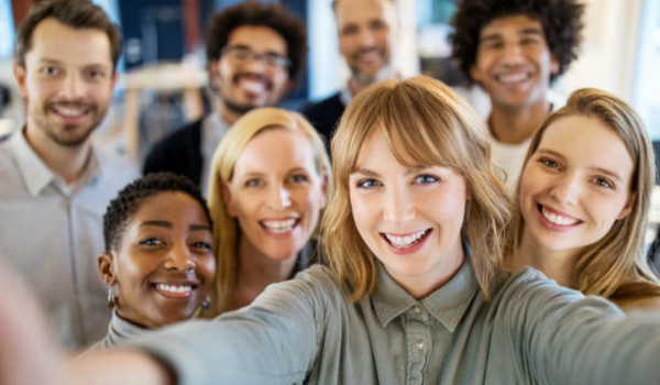 Successful business team taking selfie. Multi-ethnic business group taking a self portrait in office.